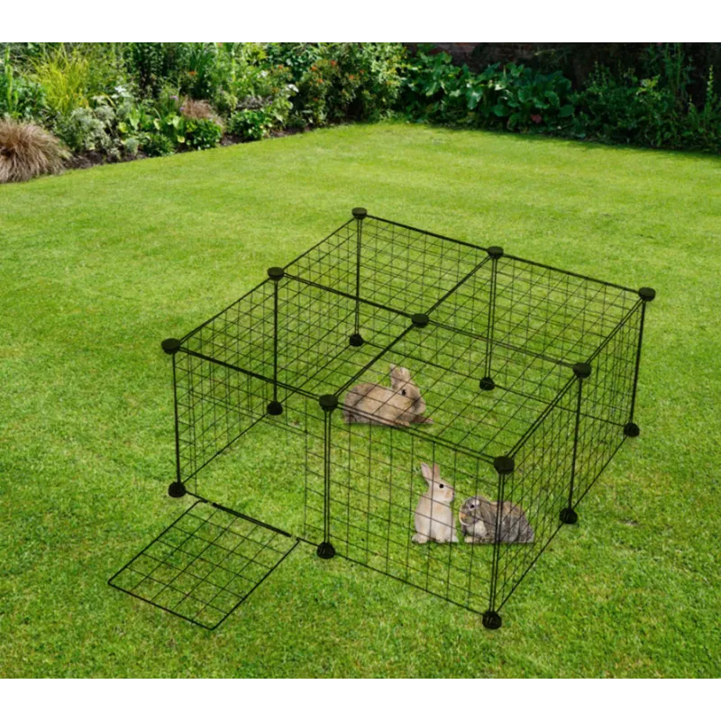 Pet playpen with small animals inside on a grassy area