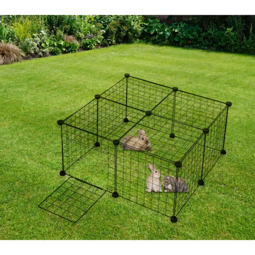 Pet playpen with small animals inside on a grassy area