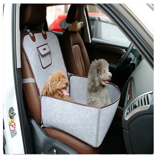 Two dogs in a car seat cover inside a vehicle.