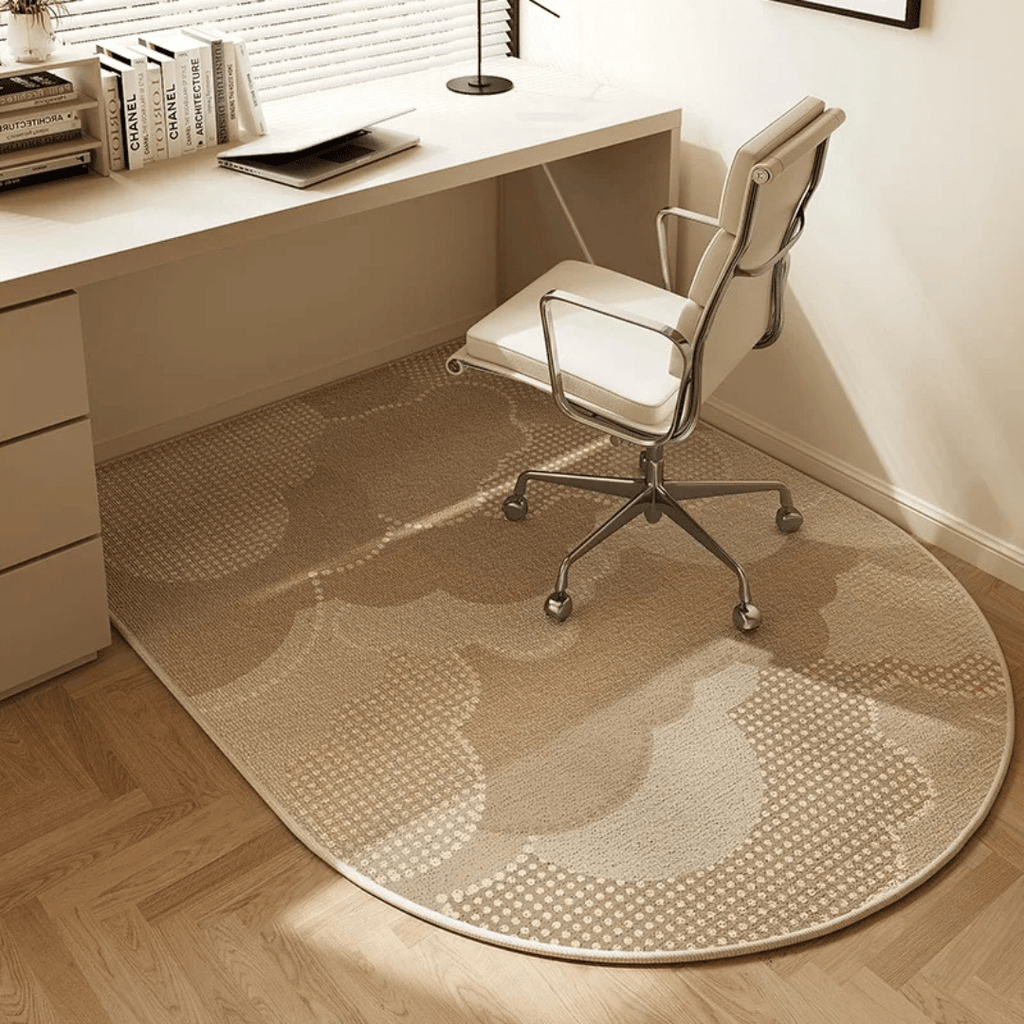 Round patterned rug on a wooden floor in front of a desk with a chair.