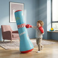 Child playing with a blue inflatable punching bag labeled 'Back to School Bang' in a room.