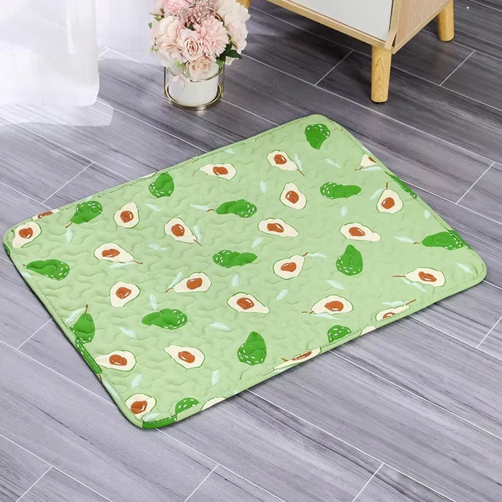 Green avocado-patterned rug on a wooden floor with a vase of flowers in the background.