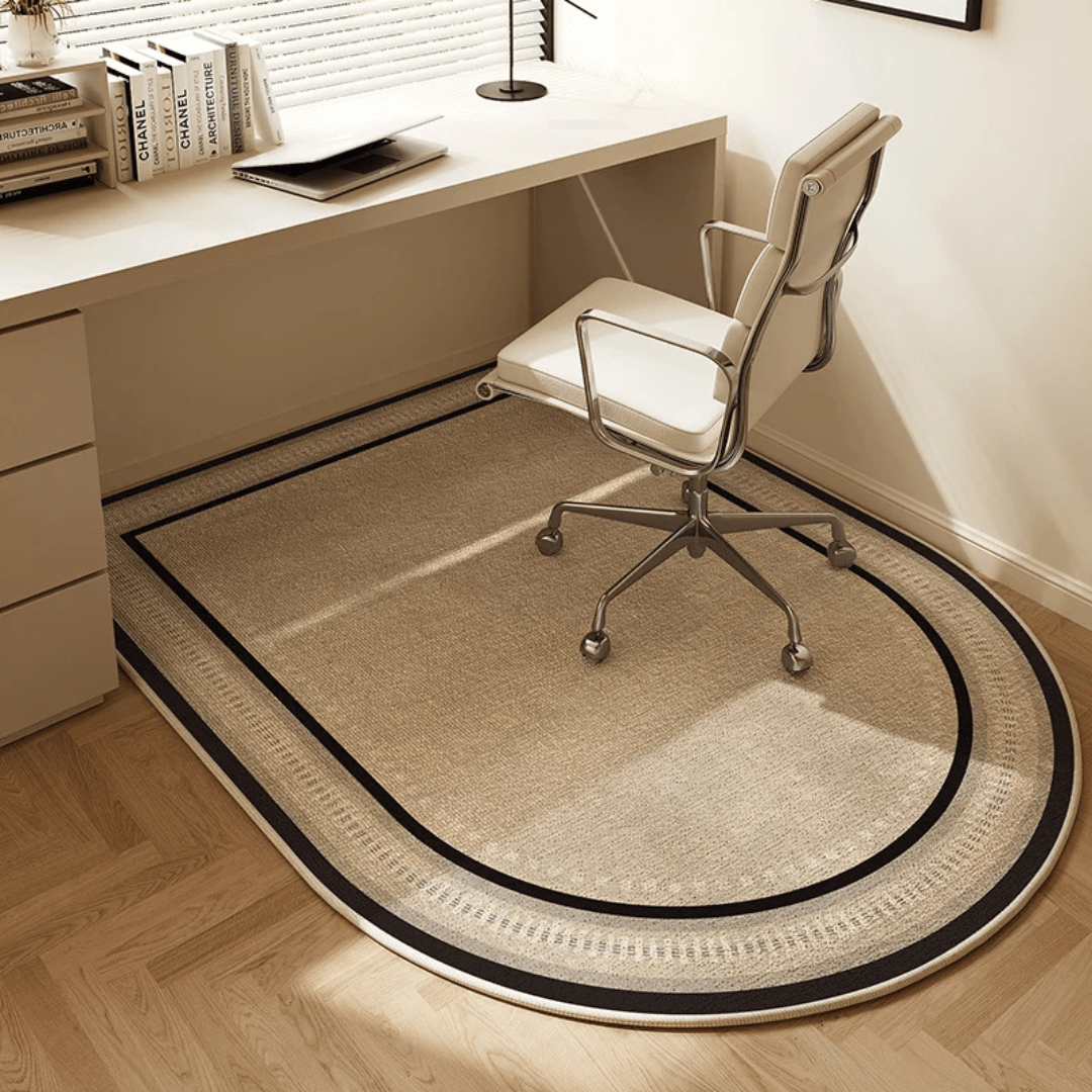 Beige office chair on a large round rug in front of a desk.