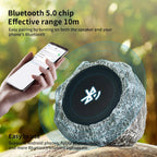 Bluetooth speaker with stone-like texture and person holding phone with Bluetooth icon, outdoors.