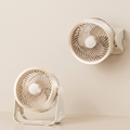 Two beige fans on a beige background
