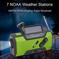 Green and black NOAA weather radio with solar panel on a dark background