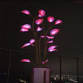 Decorative LED plant with pink lights in a pot against a dark background