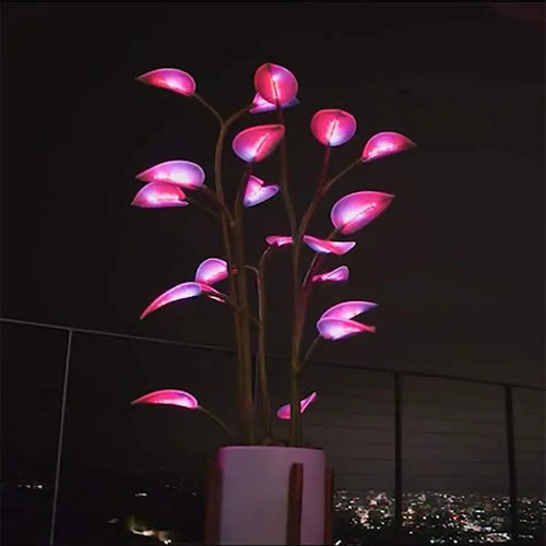 Decorative LED plant with pink lights in a pot against a dark background