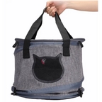 Gray pet carrier with black cat design held by a hand on a white background