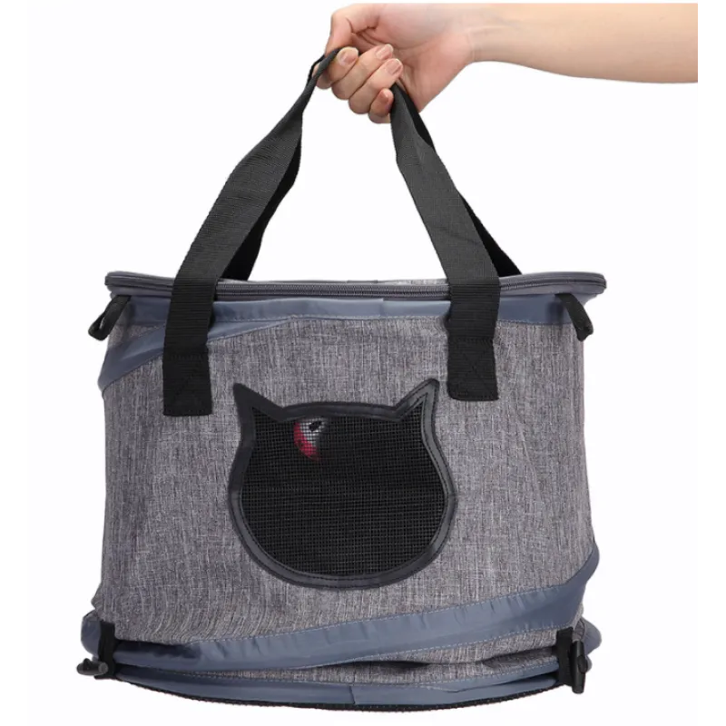 Gray pet carrier with black cat design held by a hand on a white background
