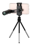 Phone with a telescope attachment on a tripod against a white background