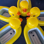 Yellow inflatable ducks with orange beaks on a dark blue background