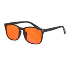 Sunglasses with black frame and orange lenses on a white background