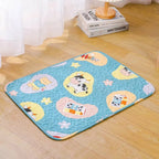 Children's play mat with cartoon designs on a wooden floor