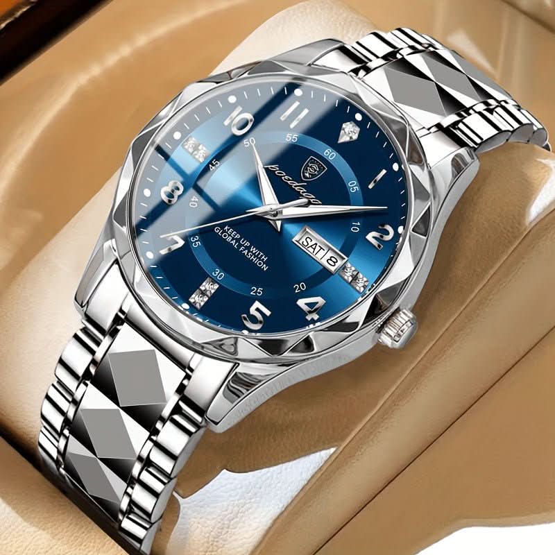 Silver watch with blue dial on a beige surface