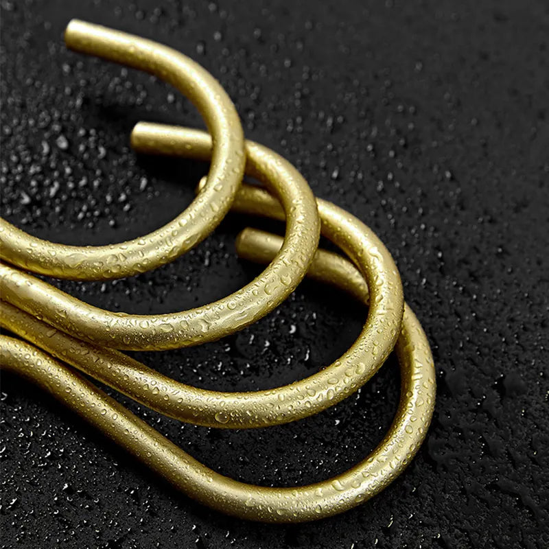 Gold metal loops on a black textured background