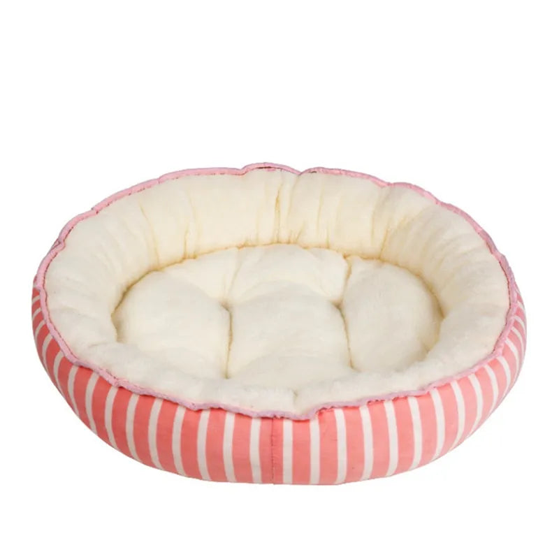 Round pet bed with pink and white striped exterior and cream interior on a white background