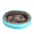 Round pet bed with gray interior and turquoise exterior on a white background