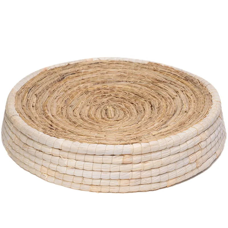 Round woven coaster with natural and white patterns on a white background