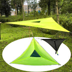 Two camping tents, one green and one black, on a grassy background with trees.