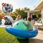 Two children playing on a large inflatable ball in a backyard setting.