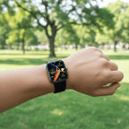 Person wearing a smartwatch with a park in the background