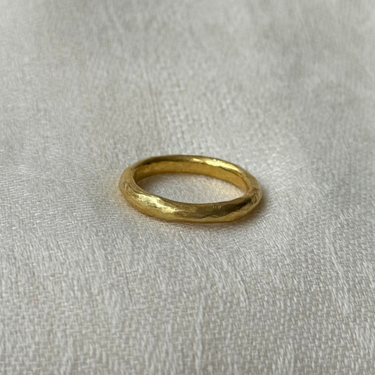 22ct Gold ring on a light gray fabric background