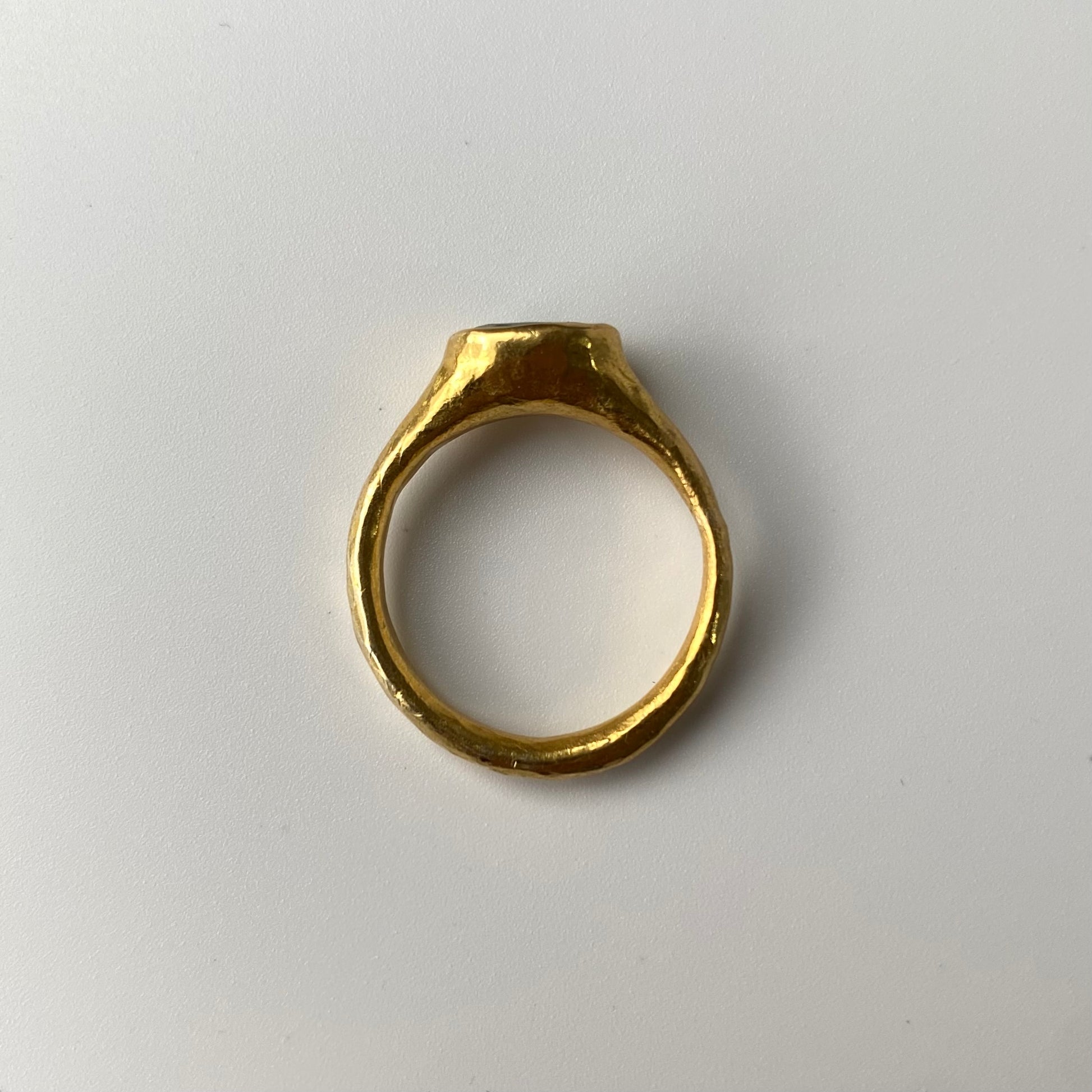 Handcrafted 22ct Gold ring on a white background