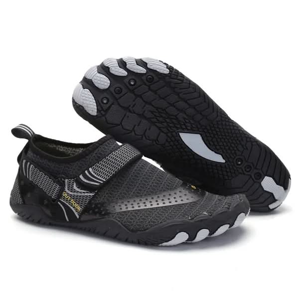 Pair of black and gray water shoes with sole texture on a white background