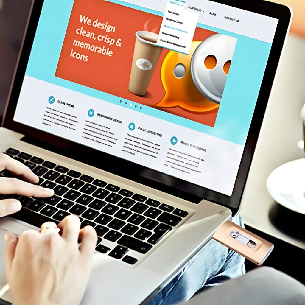 Person using a laptop with a design-themed website displayed on the screen.