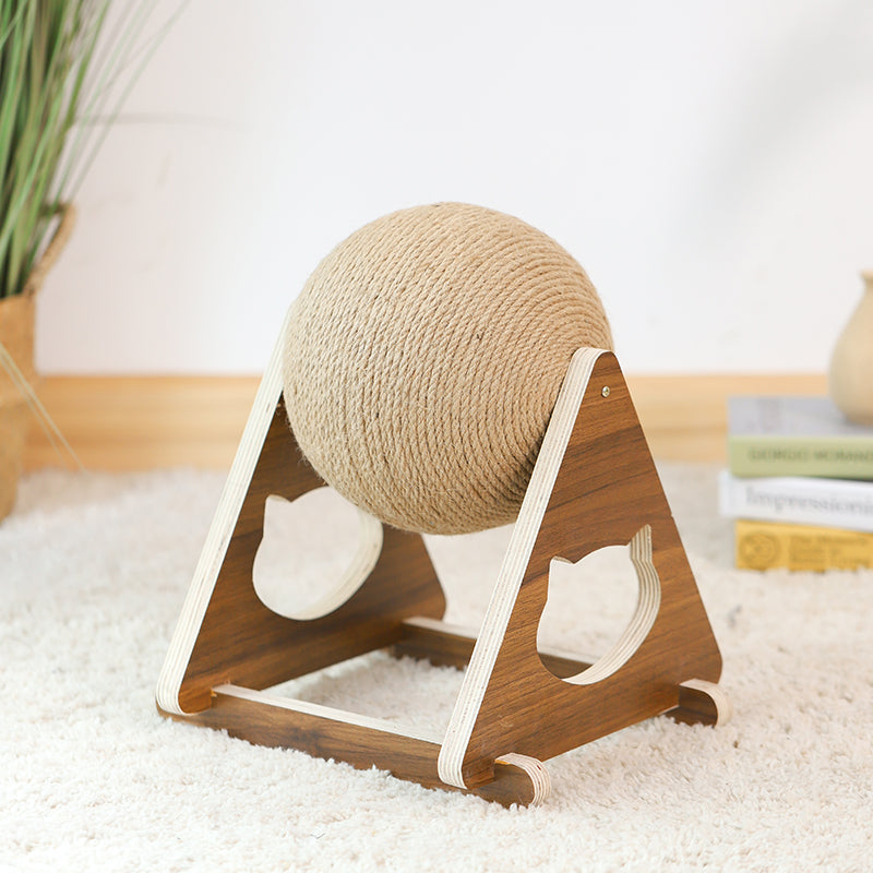 Wooden cat toy with a spherical ball on a soft surface