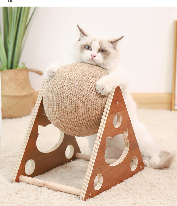 Cat playing with a ball on a wooden stand in a home setting