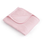 Pink blanket folded on a white background