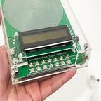 Schumann Wave Signal Generator held in a hand with a white background