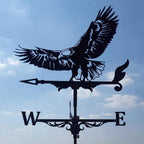 Metal weathervane shaped like an eagle against a blue sky