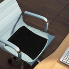 Office chair with a black seat cushion on a wooden floor.