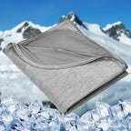 Folded gray blanket with a mountain and ice background