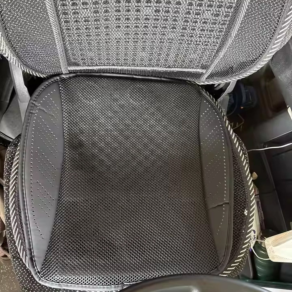 Car seat with a gray textured cover and visible wear.