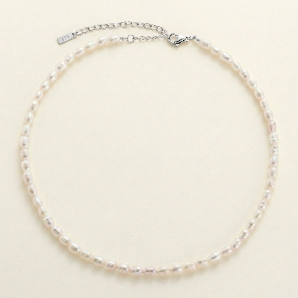 Pearl necklace on a beige background