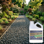 Container of 'Sticky Mulch' with a garden pathway and plants in the background