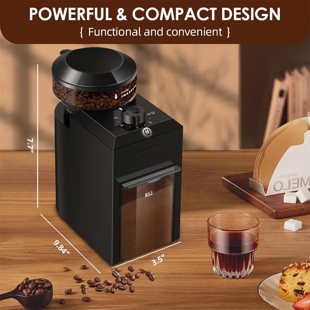 Black coffee grinder on a wooden table with coffee beans and a glass of coffee.