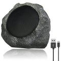 Rustic stone speaker with USB cable on a white background