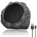 Rustic stone speaker with USB cable on a white background