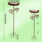 Two metal bird baths with decorative elements on a green background, showing measurements.