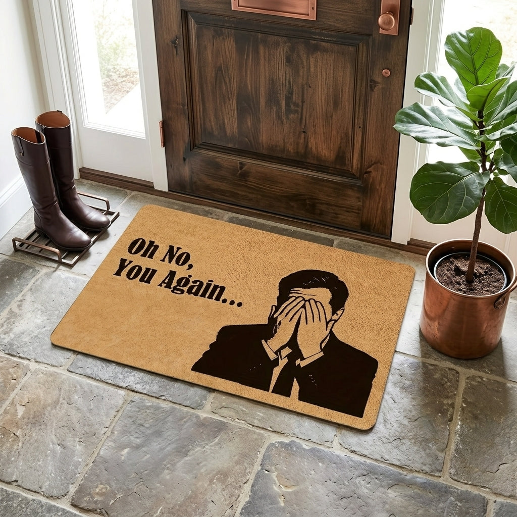 Doormat with a humorous design of a man covering his face and text 'Oh No, You Again...' on a stone floor.