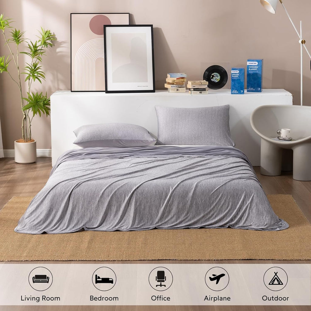 Gray bedding set on a bed in a bedroom with decor elements.