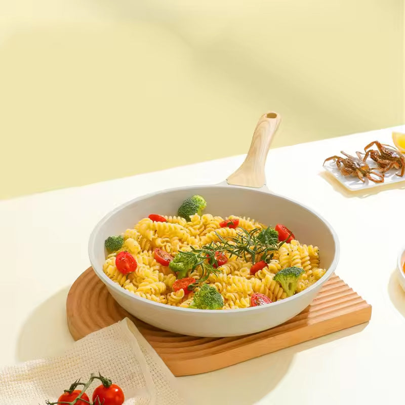Pasta dish with vegetables in a white bowl on a wooden cutting board