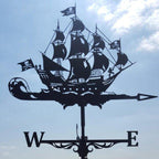 Pirate ship weathervane against a blue sky