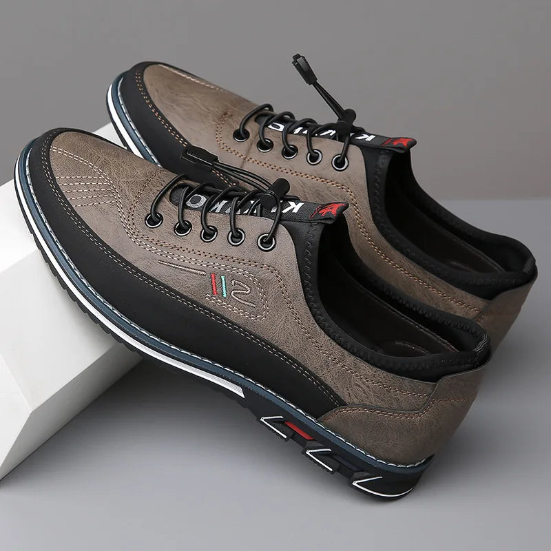 Pair of brown sneakers with black laces on a gray background