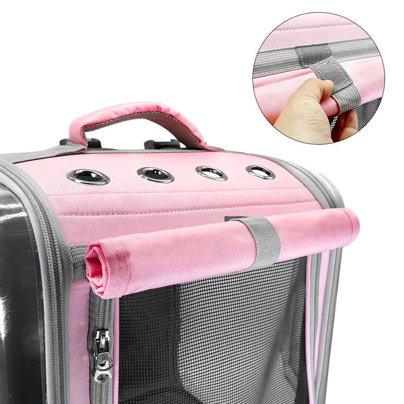 Pink pet carrier with handle and mesh side, close-up of handle on white background